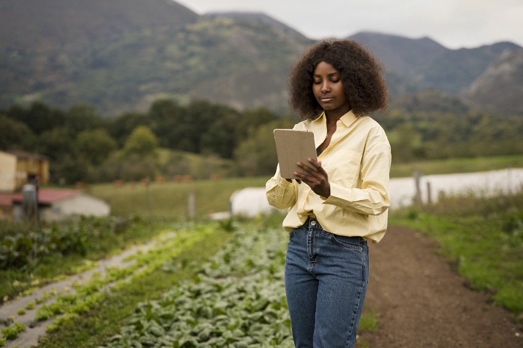 Young woman checking a tablet on a vegetable farm
